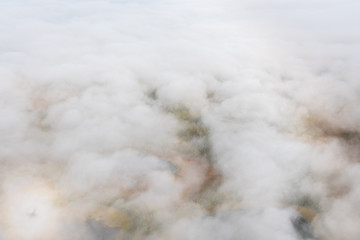 Aerial view above clouds and fog looking down at fall color on the Alaskan tundra, Katmai National Park, Alaska, USA
