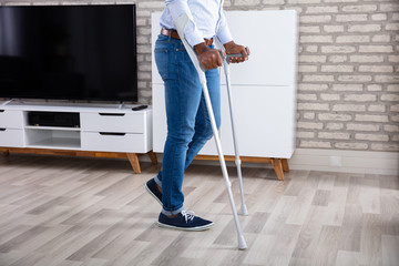 Disabled Man Walking With Crutches