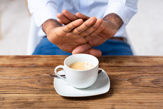 Man Refusing Cup Of Coffee