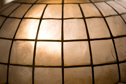 Light coming through Capiz shell lamp shade. Capiz Shells are natural seashells found in the warm waters off the Philippine Islands(also known as Windowpane oyster(Placuna placenta)).