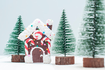 Toy gingerbread house  in christmas trees town
