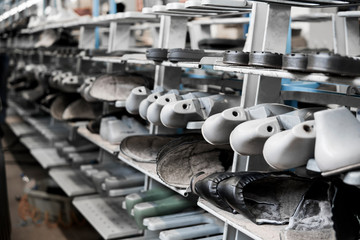 The conveyor on a shoes factory with shoe and sole. Mass production of footwear.
