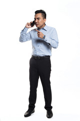 Asian man being angry while talking over the phone