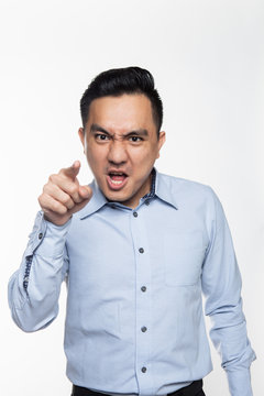 Asian man in work attire being angry pointing at the camera