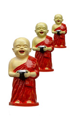 Smile young novice monk statue  on white background,culture,laughing happily novice monk