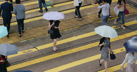 People cross the road at rain day