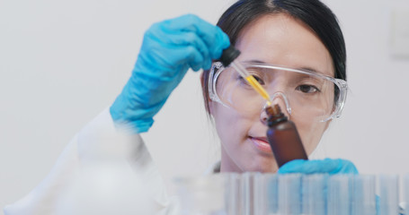 Fototapeta premium Scientist making observation of the bottle of chemical