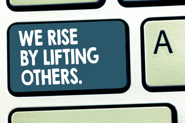 Fototapeta premium Conceptual hand writing showing We Rise By Lifting Others.. Business photo showcasing Team Spirit we feel Abundant with possibility.
