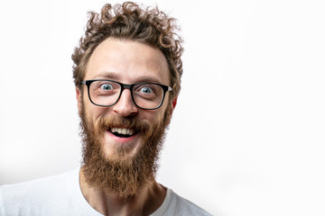 surprised bearded man in spectacles, looks with bated breath and shocked expression, keeps mouth...
