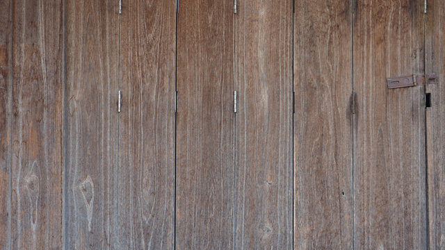 Wooden retro, vintage folding door is close, brown color tone background country shop