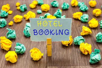 Text sign showing Hotel Booking. Conceptual photo Online Reservations Presidential Suite De Luxe Hospitality Clothespin holding gray note paper crumpled papers several tries mistakes