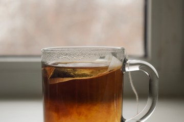 cup of tea with teabag and glass of water