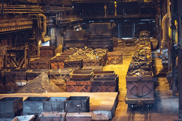 Fototapeta na wymiar Warehouse for metal processing. Railway cars with metal for melting.