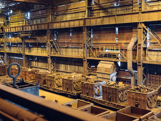 Warehouse for metal processing. Railway cars with metal for melting.