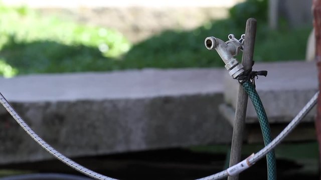 Faucet dripping water drops