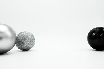 Silver, glittered and black monochrome Christmas baubles.