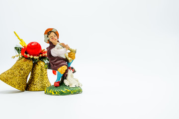 Golden glittered Christmas decoration bells and musician figure toy.