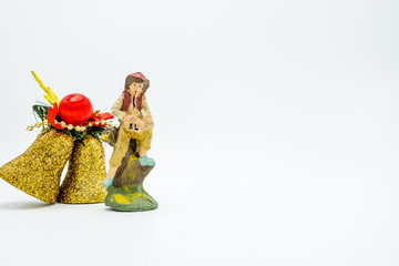 Golden glittered Christmas decoration bells and flutist figure.