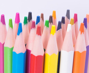multi-colored pencils, close-up, on a light background