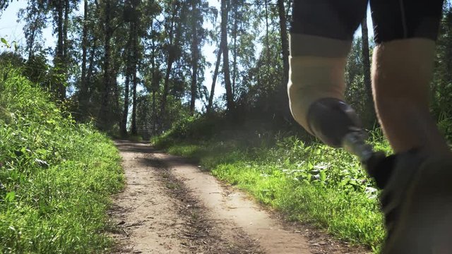 Disabled athlete with prosthetic leg running at the running track in the park