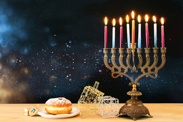 image of jewish holiday Hanukkah background with menorah (traditional candelabra) and burning candles. © tomertu