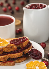 Toast with cranberry sauce, cranberry jam, cranberry tea, oranges, cranberries