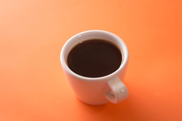 cup of coffee on orange background