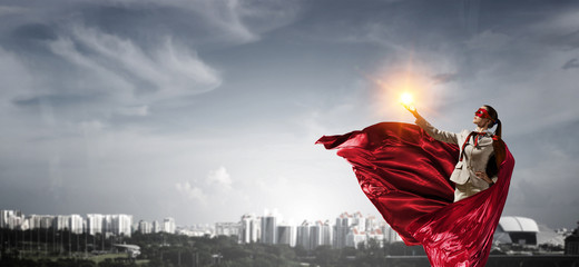 Fototapeta premium Super woman in sky. Mixed media