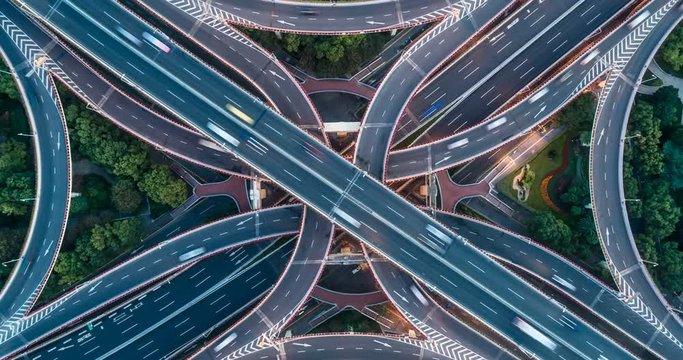 Static vertical top down aerial view of traffic on freeway interchange. timelapse
