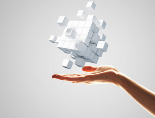 Cube white figure in male palm as symbol for integration. 3D rendering