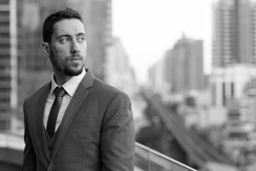 Black and white picture of young handsome Caucasian businessman 