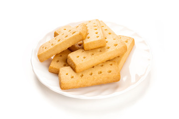 A photo of a plate of Scottish shortbread butter cookies on a white background with copy space