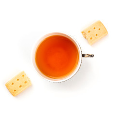 A photo of two pieces of a Scottish shortbread butter cookie, shot from the top on a white background with a vintage cup of tea, with a place for text