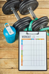 Healthy lifestyle concept. Mock up on workout and fitness dieting diary. Workout log sheet, blue...