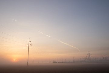 Power line in fog in the early morning