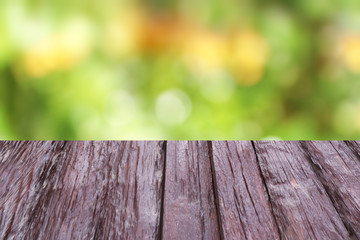 Fototapeta premium Old brown wooden floor on a background of bokeh and space for design work.