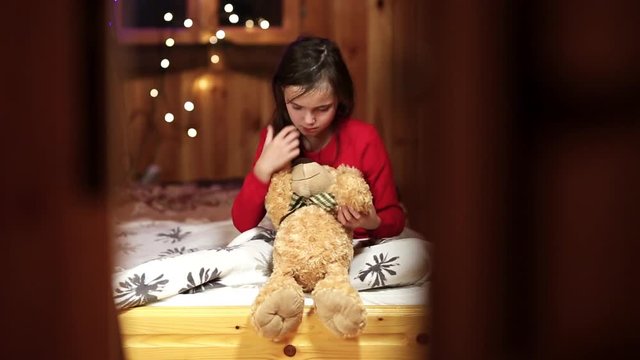 lonley young girl hug teddy bear