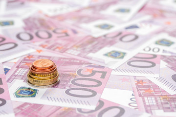 stack of euro coins on paper money