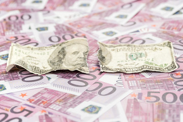 Obraz na płótnie Canvas torn dollars on euro money