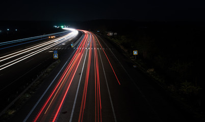 cars red and white trails of lights at night on road. long exposure photo. cars lights lines
