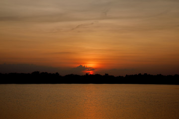Fototapeta na wymiar Beautiful sunset over the reservoir Sky background sunset