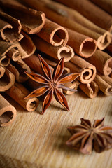  shelves of cinnamon and anise stars in dark backgrounds on a wooden background