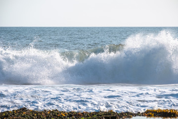 Wave crashing on coastline