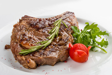  Ribeye Steak with rosemary. On a white plate