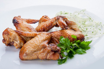 Grilled chicken wings on a white plate