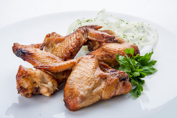 Grilled chicken wings on a white plate