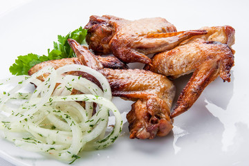 Grilled chicken wings on a white plate