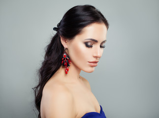 Fashion portrait of attractive brunette woman with makeup and earrings