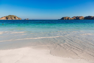 Tropical white sand beach with blue ocean in Australia