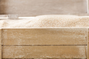 Opened wooden chest full with sand, closeup background.
